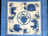 a blue and white square scarf with a picture of a horse drawn carriage