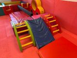 brightly colored children ' s play area with slide and ladders