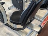 a row of stationary exercise bikes in a gym