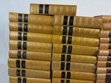 many books stacked on top of each other on a table
