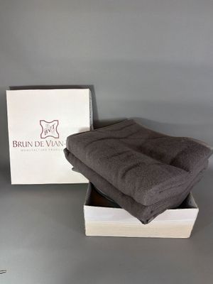 brown blanket in a white box on a table with a grey background
