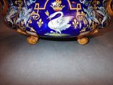 a blue bowl with a swan on it sitting on a table