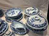 a lot of blue and white plates and bowls on a table