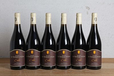 six bottles of wine are lined up on a wooden table