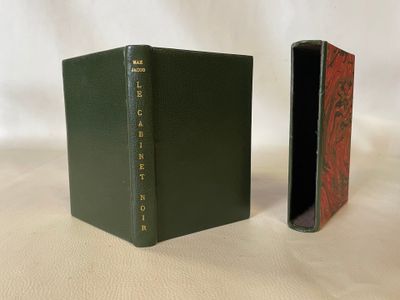 a green book sitting next to a red book