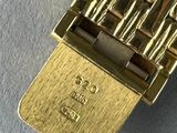 a close up of a gold plated watch on a table