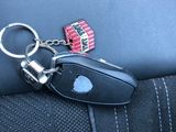 a keychain that is attached to the back seat of a car