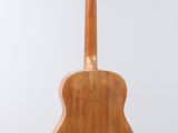 a wooden guitar on a stand against a white background