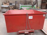 a red box with a chain attached to it in a warehouse