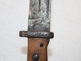 a close up of a knife on a wooden stand