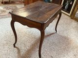 a wooden table with a drawer underneath it in a room