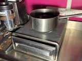 a pot on the stove with a spoon on it