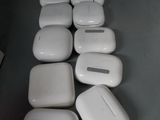 several white airpods sitting on top of a table next to a keyboard