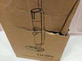a cardboard box with a vacuum on top of it
