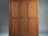 a large wooden cabinet with four doors and two drawers