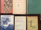 several books are sitting on a table next to each other