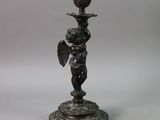 pair of bronze candlesticks with cherenshes and cherenshes on them