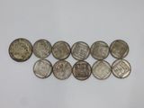 a close up of a bunch of coins on a white surface