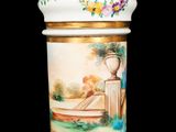 a vase with a painting on it on a black background