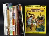 several books are stacked on top of each other on a black surface
