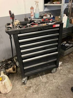a black tool cabinet with tools on it in a garage