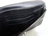 a black purse that is open on a white surface
