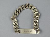 an image of a silver bracelet with a tag on it