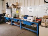 a workbench in a warehouse with a lot of items on it