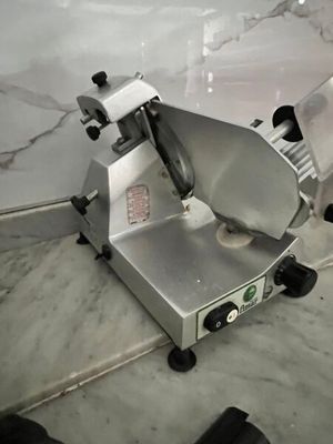 an image of a commercial meat slicer on a counter
