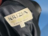 an image of a person holding a black jacket with a label on it