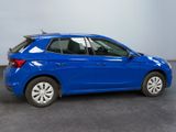 a blue car is parked in a room with a gray floor