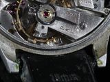 a close up of a watch with a black leather strap