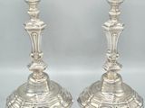 pair of silver candlesticks on a white background