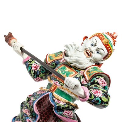 chinese figurine of a man holding a stick and wearing a colorful outfit
