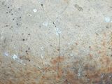 a close up of an old pot with a crack in it