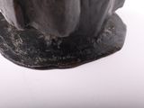 a statue of a man sitting on top of a table