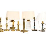 four lamps that are sitting next to each other on a table