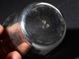 a person holding a glass of water in their hand