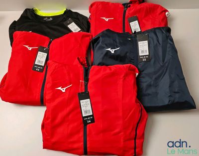 three pairs of red, black, and blue running jackets with tags on them