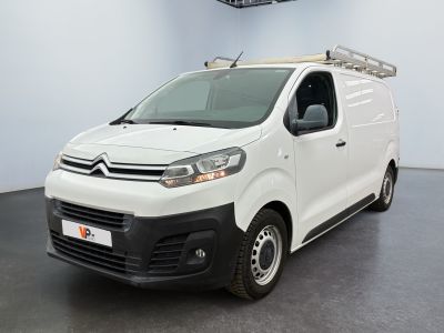 the white van is parked in a large room with a ladder on the roof
