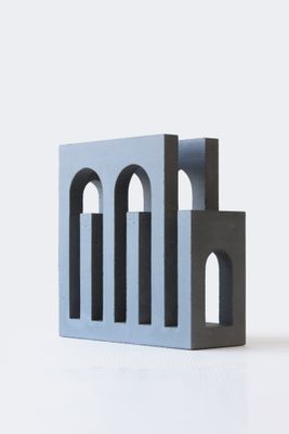 un petit bâtiment en béton situé sur une surface blanche