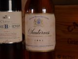two bottles of wine sitting next to each other on a table
