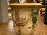 a large urn sitting on a wooden floor in a room