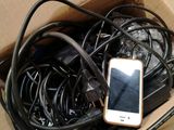 a cell phone sitting in a box of wires