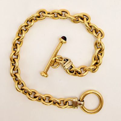 a close up of a gold chain with a key on it