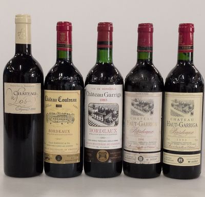 several bottles of wine are lined up on a table