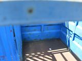 a blue container that has a metal gate in it