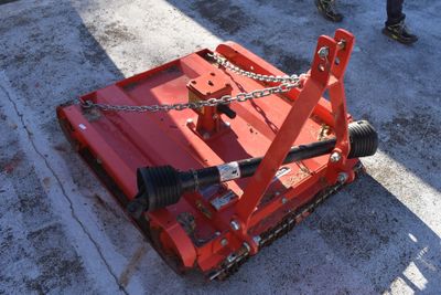 a red machine that is sitting on the ground