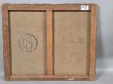 an old picture of a wooden frame with a stamp on it
