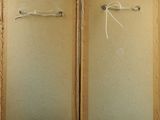 two framed pictures on the wall of a room